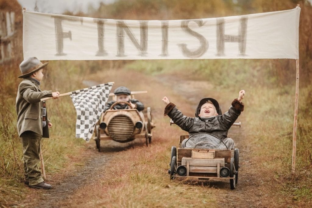 young boys racing go carts crossing the finish line representing bad a finishing things