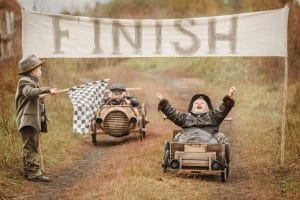 young boys racing go carts crossing the finish line representing bad a finishing things